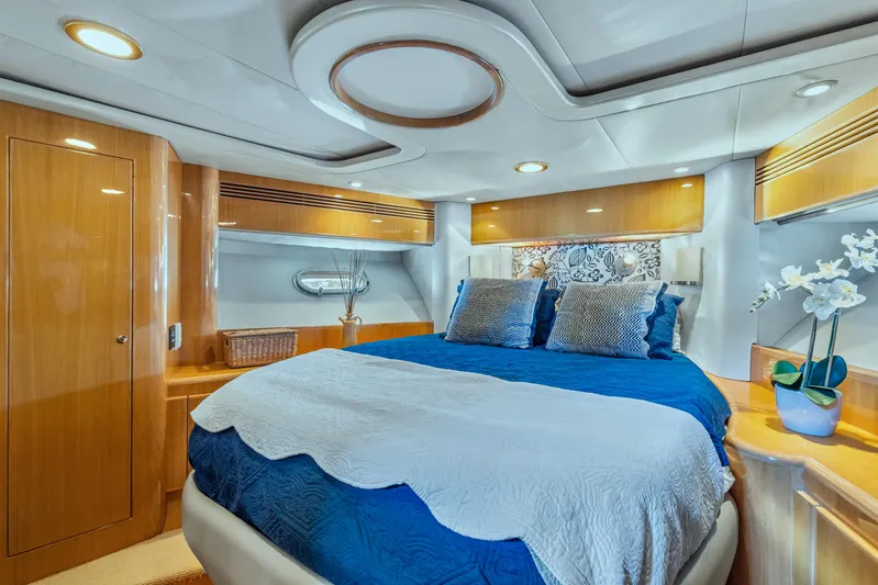  Yacht Photos Pics Luxurious bedroom interior of 2003 McKinna 58 Pilothouse yacht with elegant bedding and wood finishes.