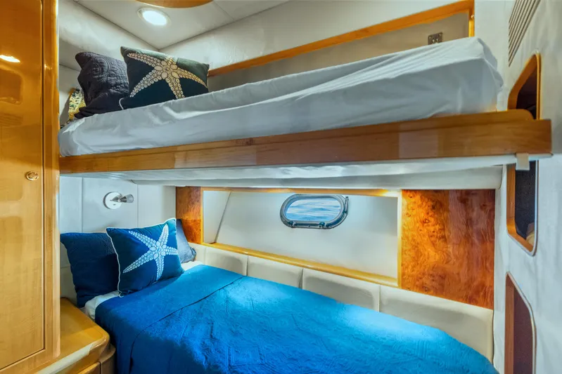  Yacht Photos Pics Bunk beds in 2003 McKinna 58 Pilothouse, featuring blue starfish-themed bedding.
