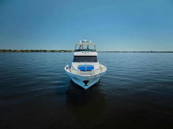  Yacht Photos Pics 2003 McKinna 58 Pilothouse yacht on calm water under clear blue sky.