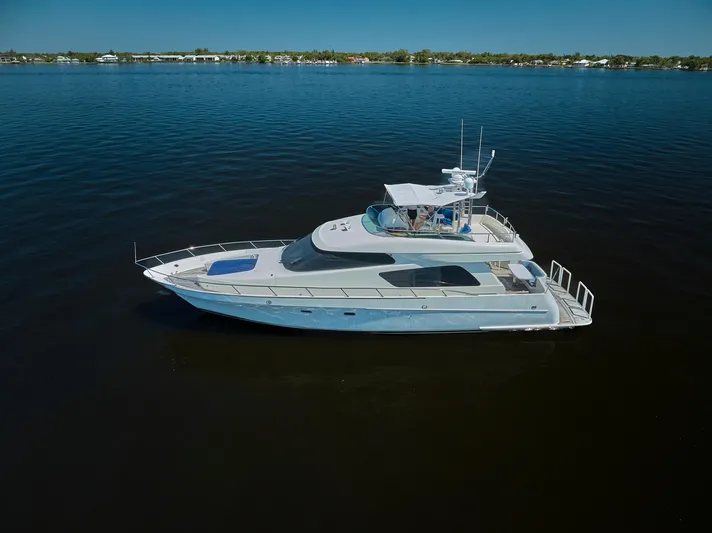  Yacht Photos Pics 2003 McKinna 58 Pilothouse yacht cruising on calm waters under clear skies.