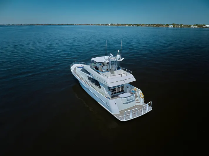  Yacht Photos Pics 2003 McKinna 58 Pilothouse yacht cruising on calm waters under clear skies.