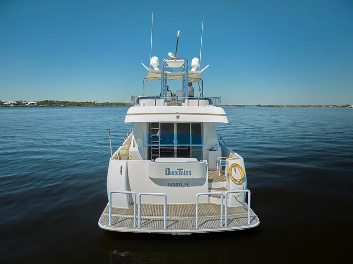  Yacht Photos Pics 2003 McKinna 58 Pilothouse yacht on calm water, rear view.