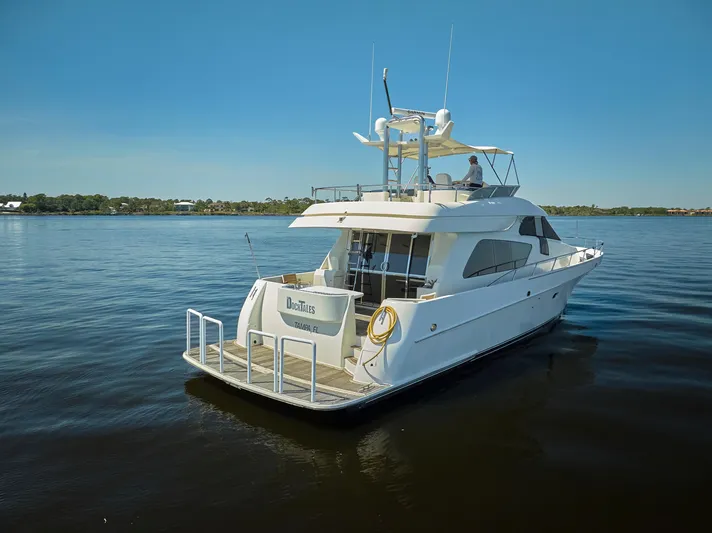  Yacht Photos Pics 2003 McKinna 58 Pilothouse yacht on calm water under clear blue sky.