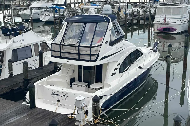 Beira Mar Yacht Photos Pics 2005 Sea Ray 420 Sedan Bridge yacht docked at marina, surrounded by other boats.