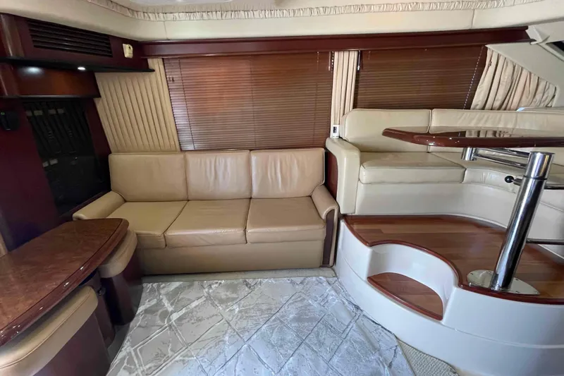 Beira Mar Yacht Photos Pics Luxurious interior of 2005 Sea Ray 420 Sedan Bridge with leather seating and wooden accents.