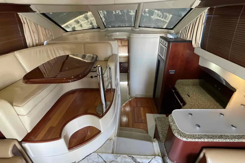 Beira Mar Yacht Photos Pics Luxurious interior of 2005 Sea Ray 420 Sedan Bridge yacht with elegant seating and kitchen area.