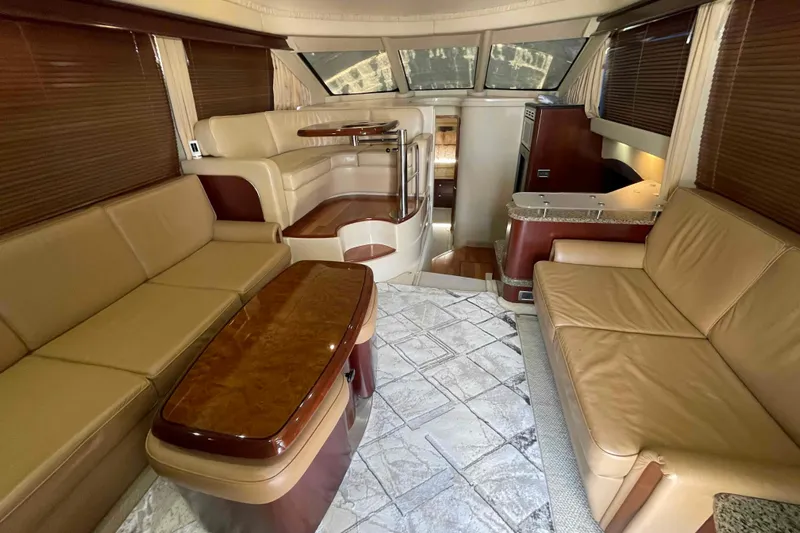 Beira Mar Yacht Photos Pics Luxurious interior of 2005 Sea Ray 420 Sedan Bridge with leather seating and elegant wood finishes.