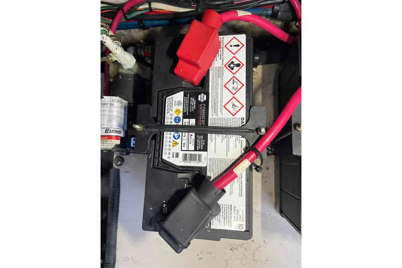 Beira Mar Yacht Photos Pics Battery setup in a 2005 Sea Ray 420 Sedan Bridge with red cables and safety labels.