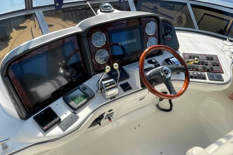 Beira Mar Yacht Photos Pics Helm of 2005 Sea Ray 420 Sedan Bridge with Garmin navigation system and wooden steering wheel.