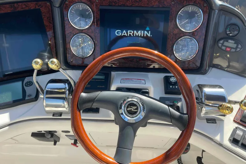 Beira Mar Yacht Photos Pics 2005 Sea Ray 420 Sedan Bridge helm with Garmin display and wood-accented steering wheel.
