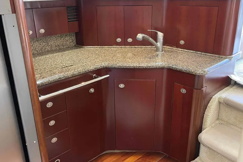 Beira Mar Yacht Photos Pics Luxurious kitchen area in 2005 Sea Ray 420 Sedan Bridge yacht with granite countertops.