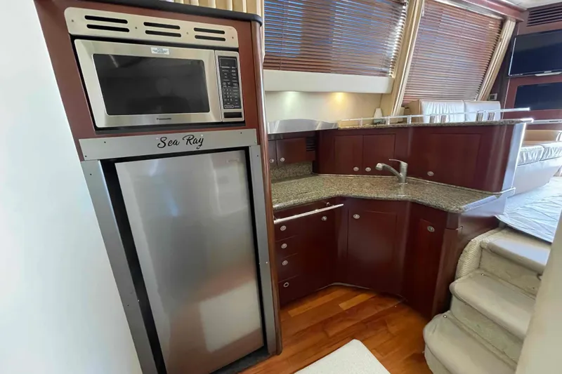 Beira Mar Yacht Photos Pics Luxurious 2005 Sea Ray 420 Sedan Bridge yacht kitchen with modern appliances and wood cabinetry.