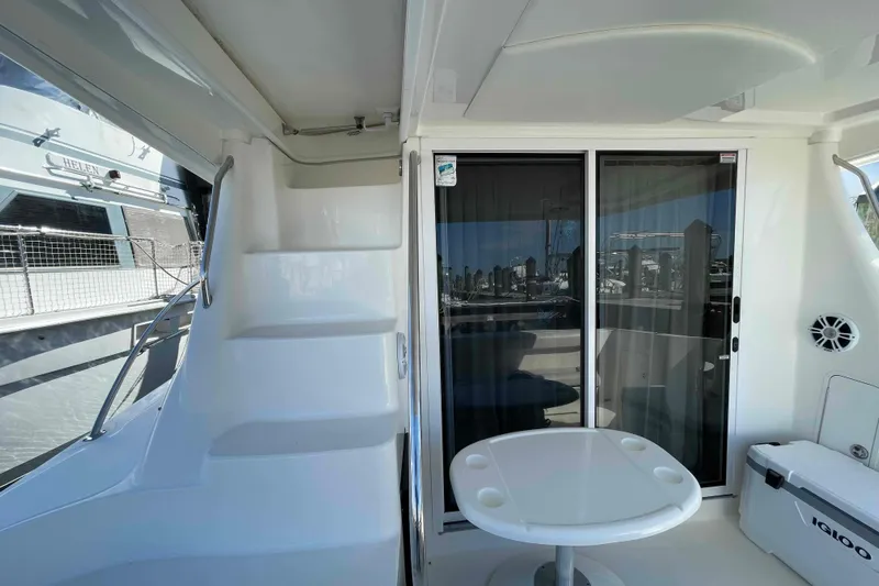 Beira Mar Yacht Photos Pics 2005 Sea Ray 420 Sedan Bridge yacht interior with stairs, table, and sliding glass doors.