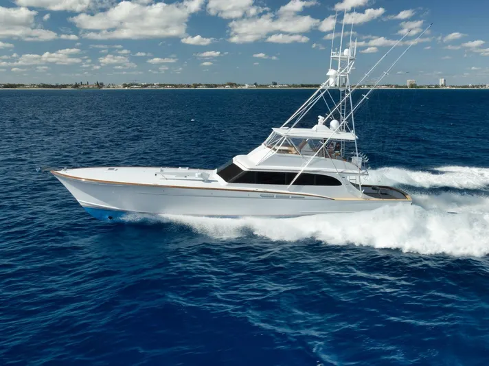 Pescaria Yacht Photos Pics 2009 Rybovich Custom Convertible yacht cruising on open blue sea under a partly cloudy sky.