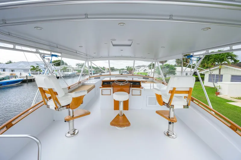 Pescaria Yacht Photos Pics 2009 Rybovich Custom Convertible yacht helm with white seating and wooden accents.