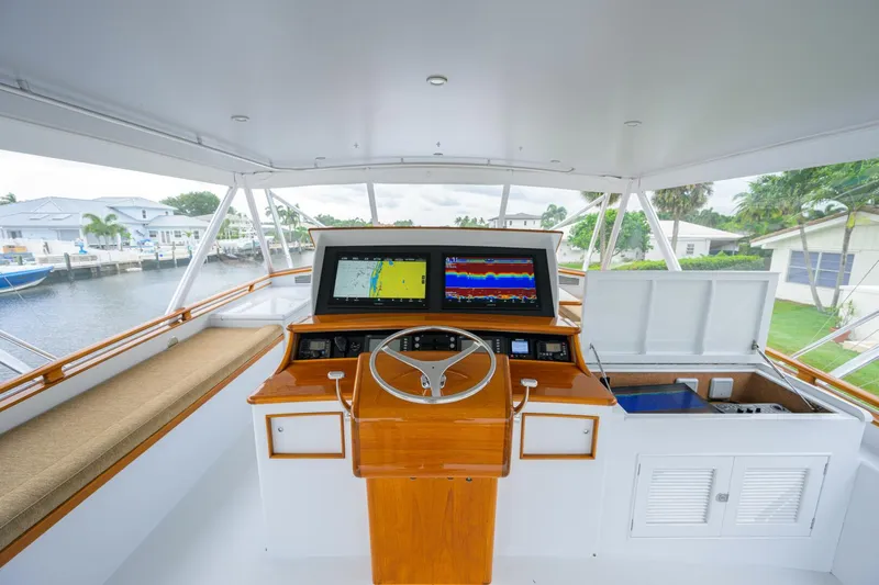 Pescaria Yacht Photos Pics 2009 Rybovich Custom Convertible yacht helm with navigation screens and wooden steering wheel.