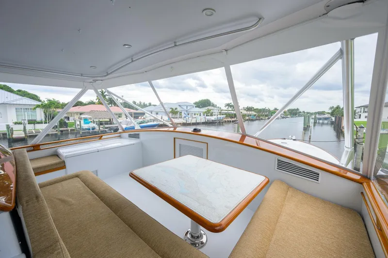 Pescaria Yacht Photos Pics 2009 Rybovich Custom Convertible yacht interior with seating and table, overlooking marina.