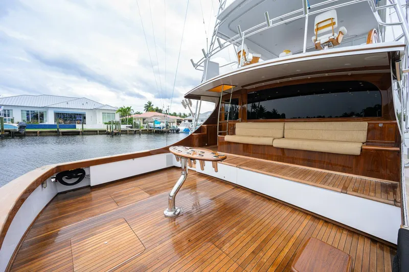 Pescaria Yacht Photos Pics 2009 Rybovich Custom Convertible yacht with wooden deck and seating area by the water.