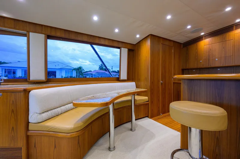 Pescaria Yacht Photos Pics Luxurious interior of 2009 Rybovich Custom Convertible yacht with wood paneling and seating area.
