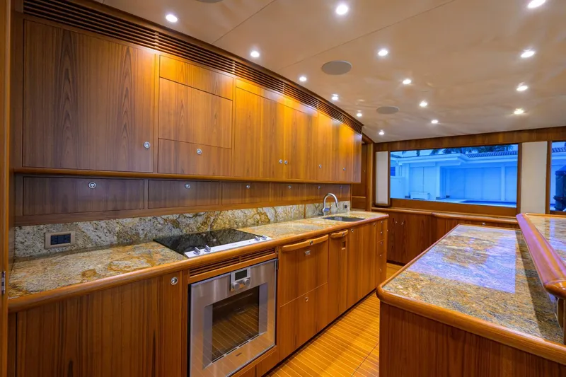 Pescaria Yacht Photos Pics Luxurious 2009 Rybovich Custom Convertible yacht kitchen with wood cabinetry and granite countertops.