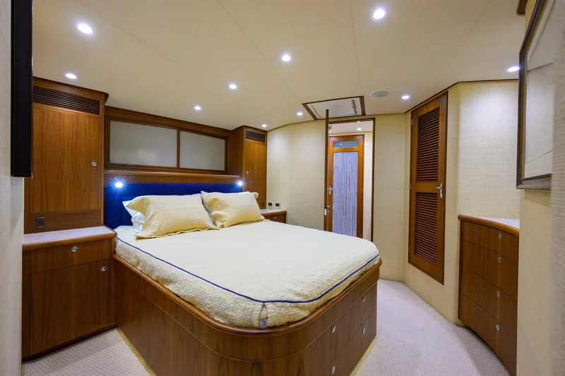Pescaria Yacht Photos Pics Luxurious bedroom interior of 2009 Rybovich Custom Convertible yacht with elegant wood finishes.
