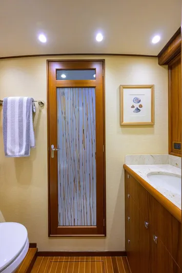 Pescaria Yacht Photos Pics Luxurious bathroom in 2009 Rybovich Custom Convertible yacht with wood accents and modern fixtures.