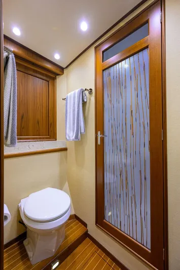 Pescaria Yacht Photos Pics Luxurious bathroom in 2009 Rybovich Custom Convertible yacht with wood accents and modern fixtures.