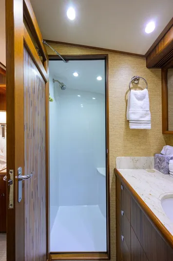 Pescaria Yacht Photos Pics Luxurious bathroom in 2009 Rybovich Custom Convertible yacht with modern shower and elegant wood finishes.