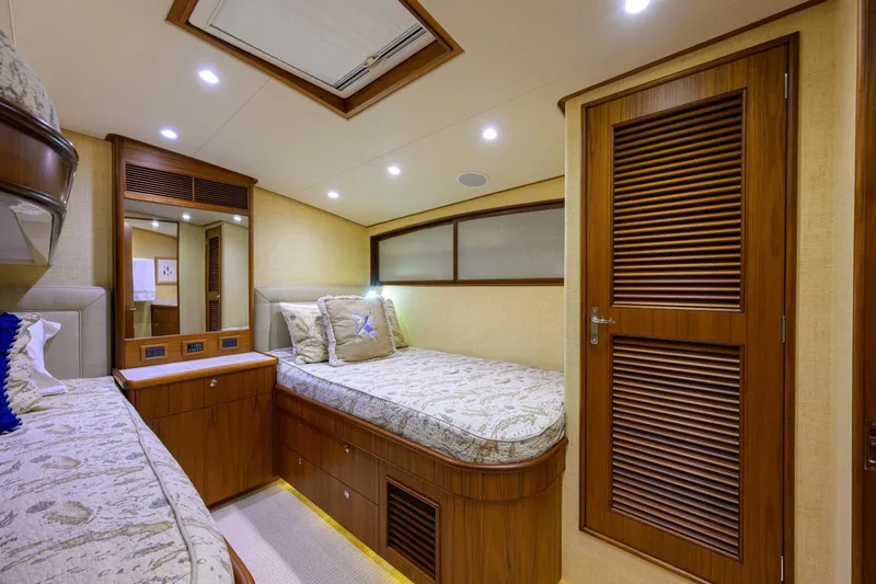 Pescaria Yacht Photos Pics Luxurious cabin interior of 2009 Rybovich Custom Convertible yacht with twin beds and wooden accents.