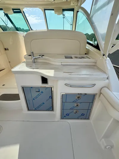  Yacht Photos Pics 2025 Grady-White Freedom 375 boat interior with kitchenette and storage cabinets.