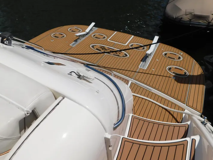  Yacht Photos Pics 2004 Sea Ray 600 Sun Sport yacht with teak deck, docked on water.