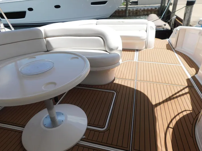  Yacht Photos Pics 2004 Sea Ray 600 Sun Sport yacht deck with white seating and round table.