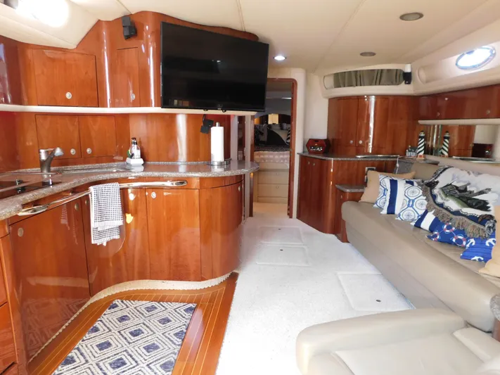  Yacht Photos Pics Luxurious interior of 2004 Sea Ray 600 Sun Sport yacht with wood cabinetry and plush seating.