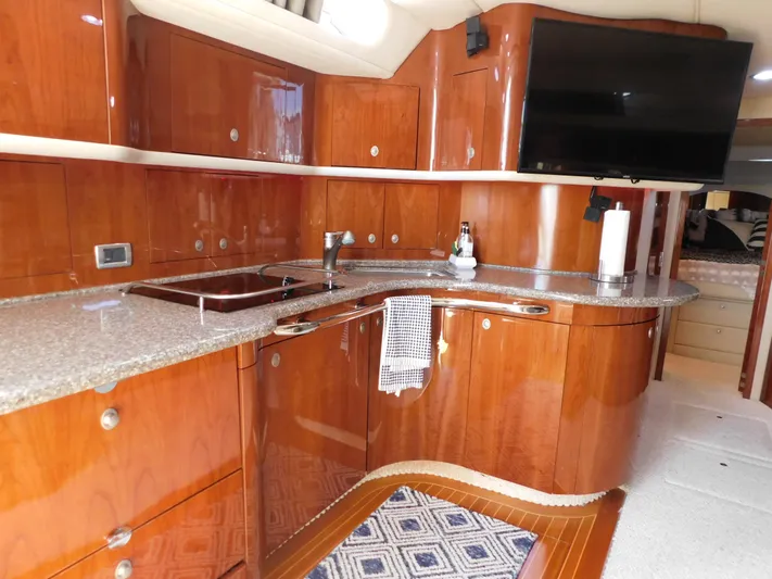  Yacht Photos Pics Luxurious 2004 Sea Ray 600 Sun Sport yacht interior with sleek wooden cabinetry and modern amenities.