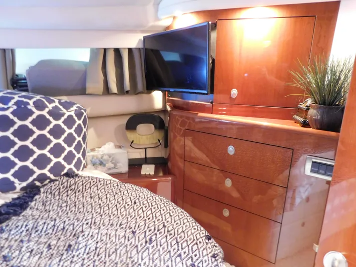  Yacht Photos Pics Luxurious cabin interior of 2004 Sea Ray 600 Sun Sport yacht with TV and wooden cabinetry.