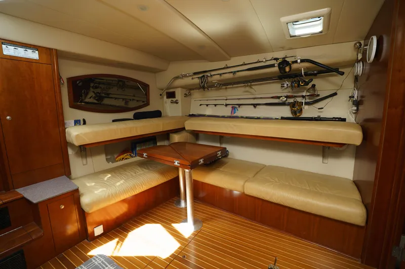 Hi Ho Silver Yacht Photos Pics Interior of 2011 Rampage 41 Express boat with fishing rods and seating area.