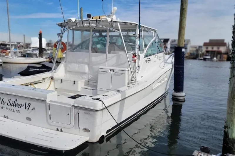 Hi Ho Silver Yacht Photos Pics 2011 Rampage 41 Express boat docked in marina, rear view, clear sky.