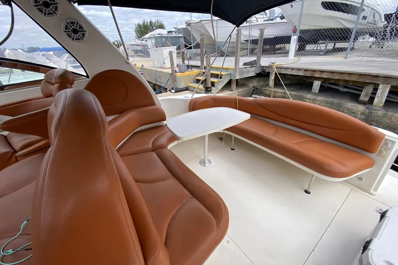Wild Card Yacht Photos Pics 2004 Sea Ray 380 Sundancer interior with brown leather seating and white table.