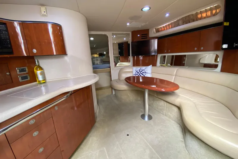 Wild Card Yacht Photos Pics Luxurious interior of 2004 Sea Ray 380 Sundancer yacht with elegant seating and cabinetry.