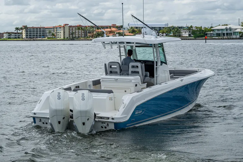  Yacht Photos Pics 2023 Boston Whaler 330 Outrage boat on water, featuring dual engines and sleek design.