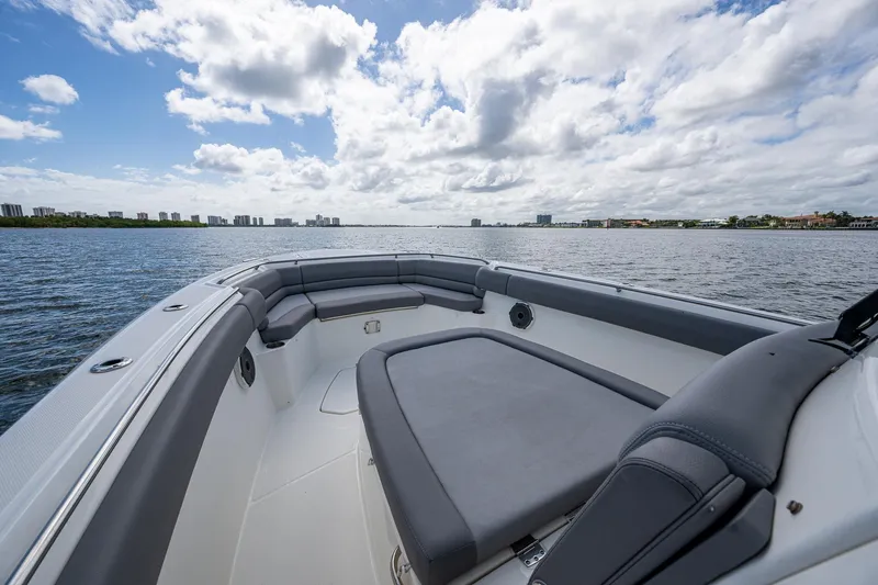  Yacht Photos Pics 2023 Boston Whaler 330 Outrage boat on open water under a cloudy sky.