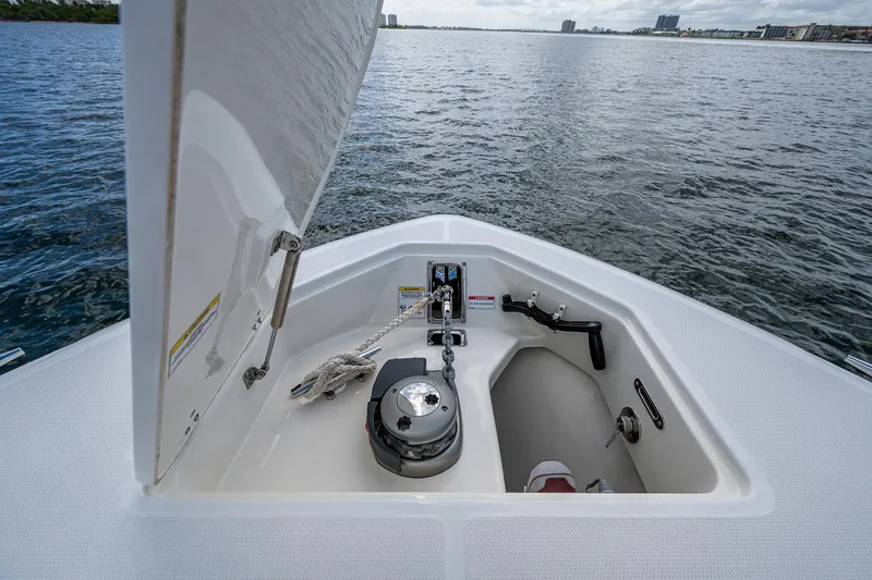  Yacht Photos Pics 2023 Boston Whaler 330 Outrage anchor compartment with ocean view in the background.