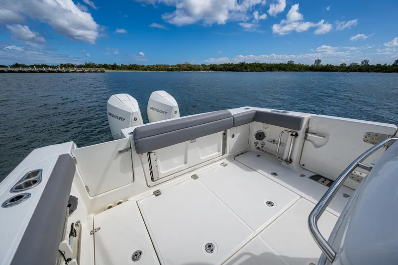  Yacht Photos Pics 2023 Boston Whaler 330 Outrage boat deck with twin engines on a sunny day.