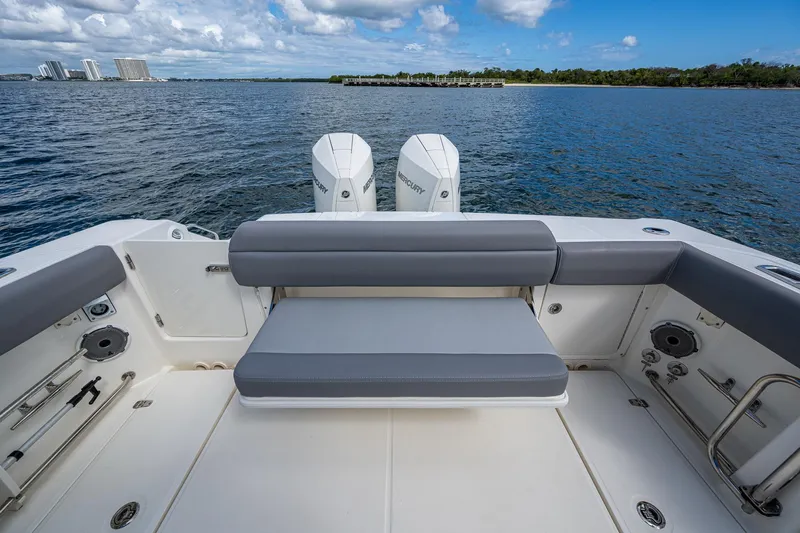  Yacht Photos Pics 2023 Boston Whaler 330 Outrage boat interior with seating and twin engines on a calm sea.