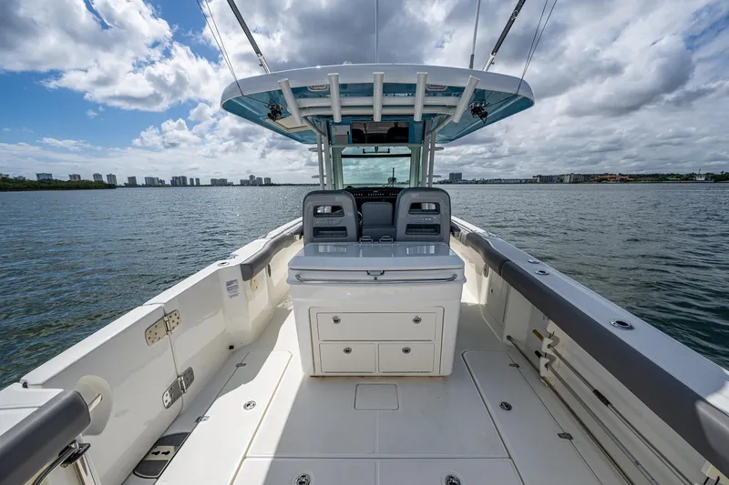  Yacht Photos Pics 2023 Boston Whaler 330 Outrage boat on water, featuring spacious deck and modern design.
