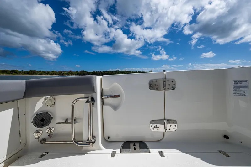  Yacht Photos Pics 2023 Boston Whaler 330 Outrage boat interior with blue sky and clouds.