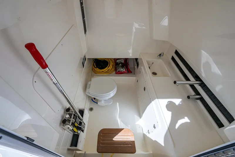  Yacht Photos Pics 2023 Boston Whaler 330 Outrage interior with toilet and storage space.