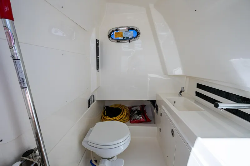  Yacht Photos Pics 2023 Boston Whaler 330 Outrage interior with toilet and sink.