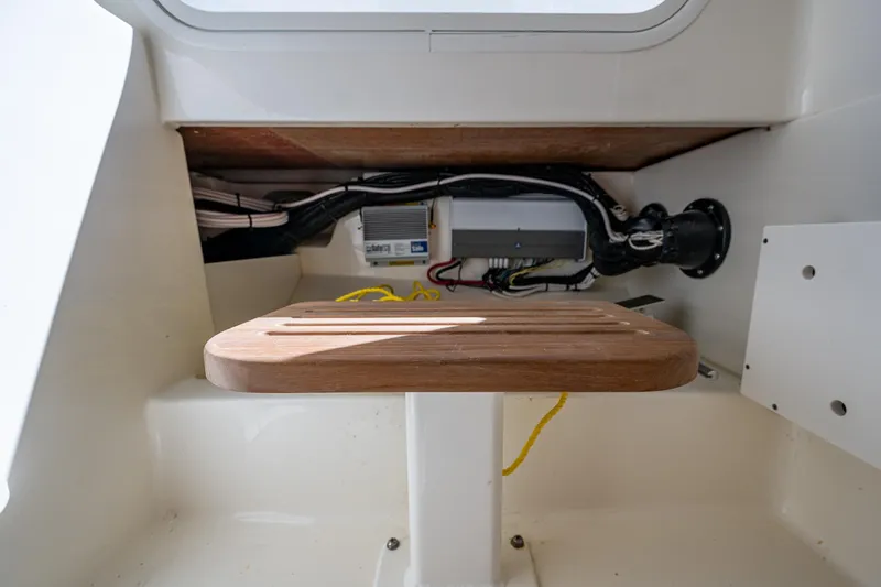  Yacht Photos Pics Interior view of 2023 Boston Whaler 330 Outrage boat, showcasing storage and wiring.