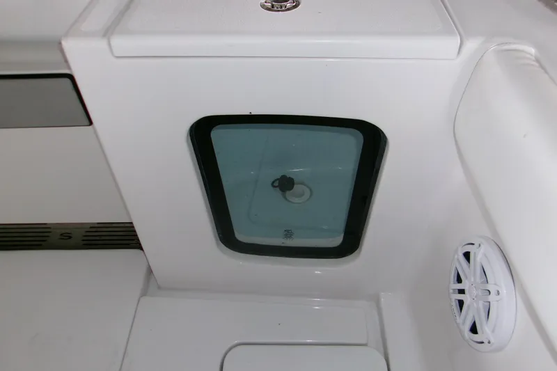  Yacht Photos Pics 2023 Sportsman Open 282 Center Console interior detail with storage compartment and speaker.